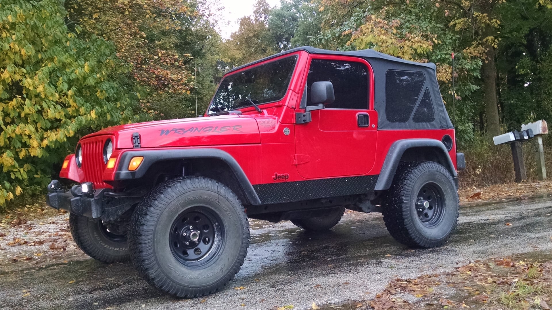 Red Rangler, a red 2006 Jeep Wrangler TJ on 33-inch tires with a 2.5-inch lift, photo 11 of 26