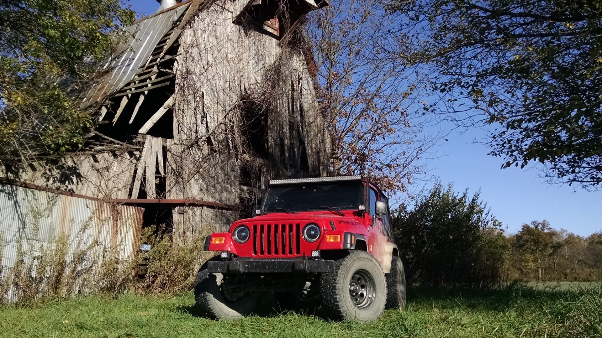 Red Rangler, a red 2006 Jeep Wrangler TJ on 33-inch tires with a 2.5-inch lift, photo 10 of 26