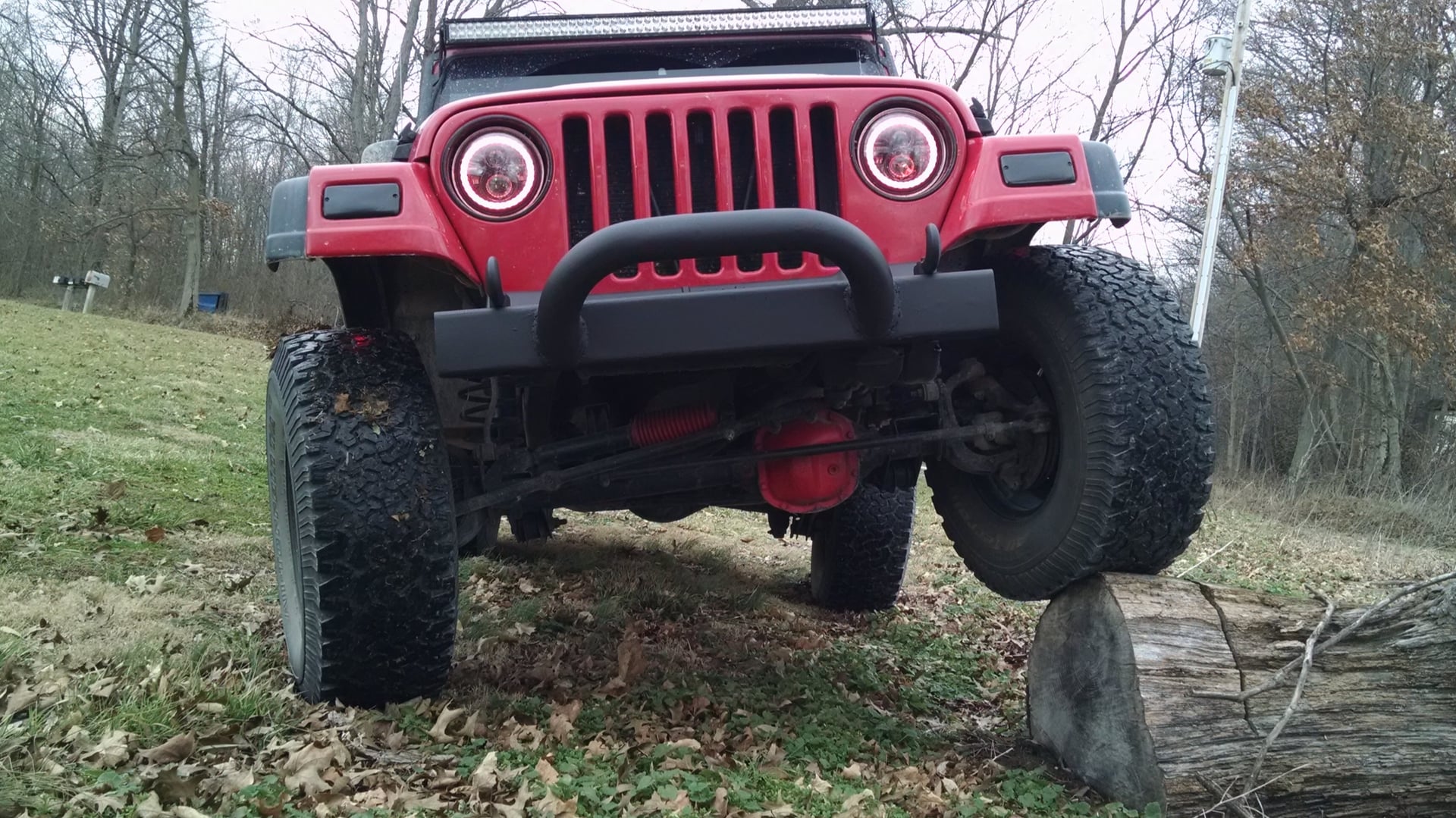 Red Rangler, a red 2006 Jeep Wrangler TJ on 33-inch tires with a 2.5-inch lift, photo 14 of 26