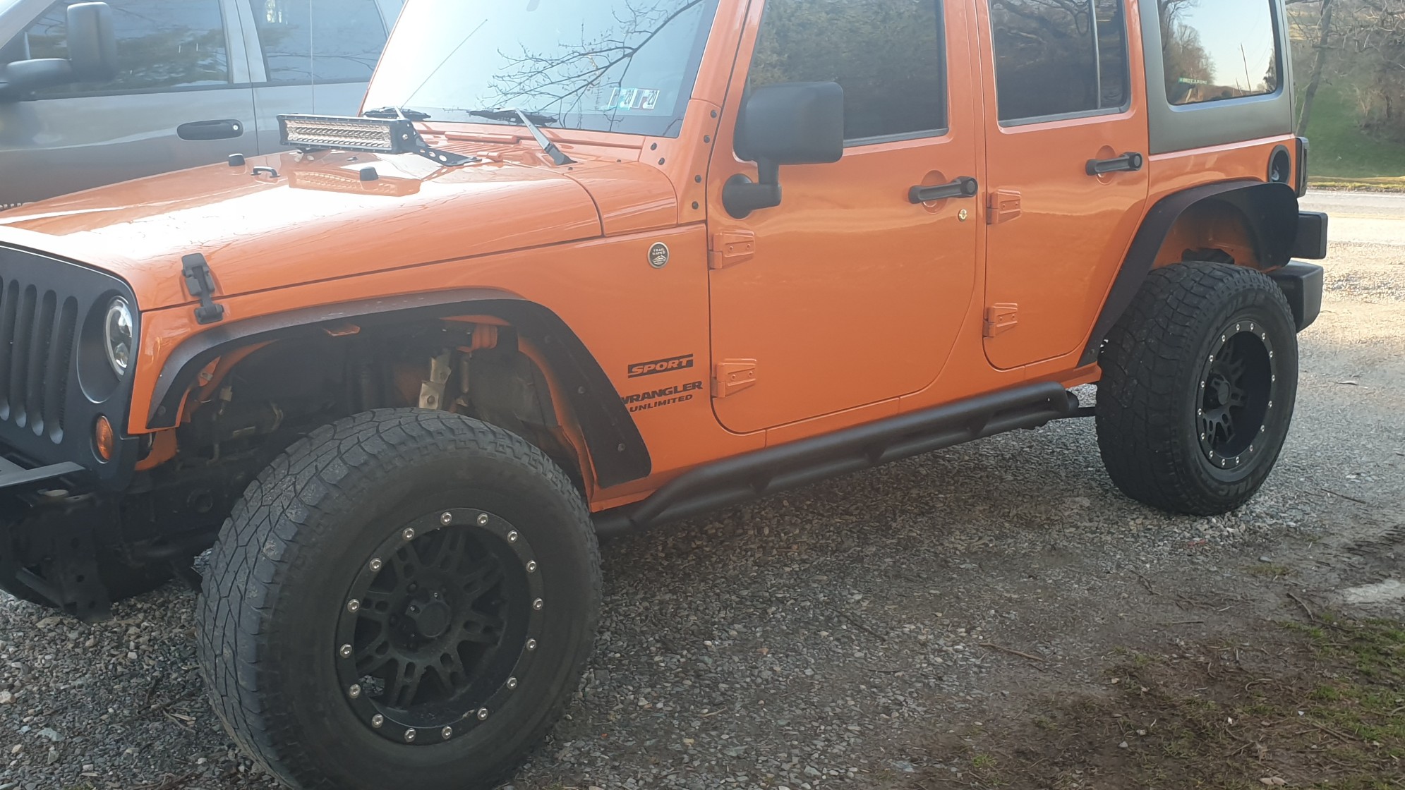 Krawler Of Christ, an orange 2012 Jeep Wrangler JKU on 38-inch tires with a 3.5-inch lift, photo 26 of 30